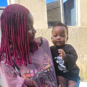 woman holding a smiling baby at Grace Day